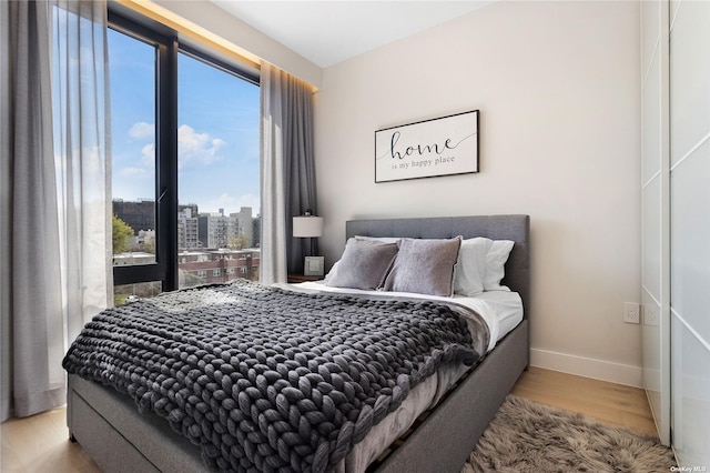 14-54 31st Ave Unit 3A, Astoria, NY 11106 - bedroom featuring wood finished floors and a city view