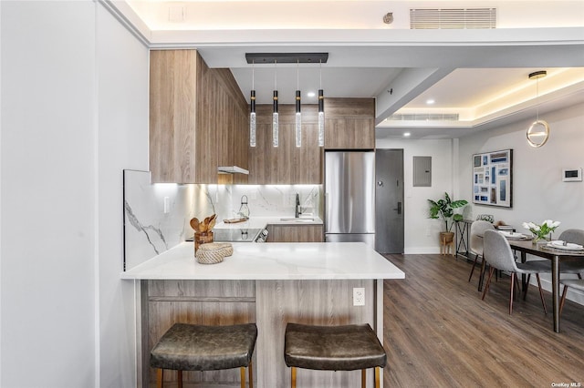 14-54 31st Ave Unit 3A, Astoria, NY 11106 - kitchen featuring modern cabinets, freestanding refrigerator, light countertops, a peninsula, and brown cabinets