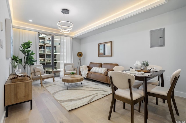 14-54 31st Ave Unit 3A, Astoria, NY 11106 - living room with a tray ceiling, electric panel, wood finished floors, and a chandelier