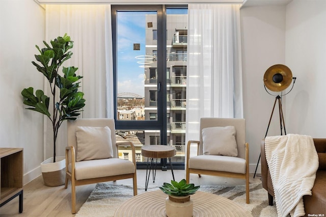 14-54 31st Ave Unit 3A, Astoria, NY 11106 - sitting room featuring wood finished floors and expansive windows