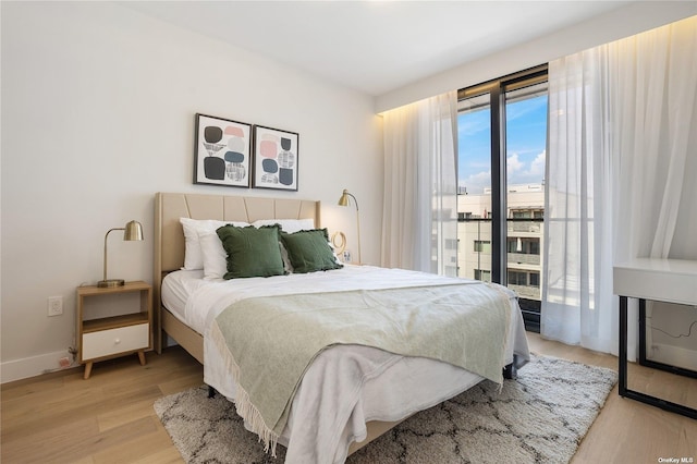 14-54 31st Ave Unit 3A, Astoria, NY 11106 - bedroom with light wood-type flooring and baseboards