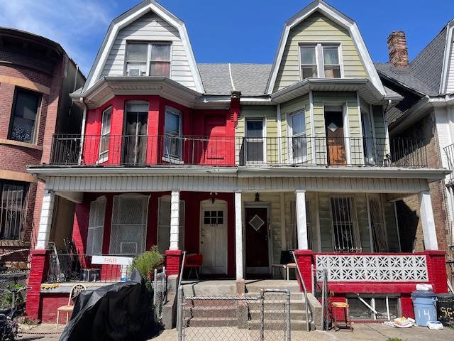1405 36th St, Brooklyn, NY 11218 - colonial inspired home with a porch, a balcony, and a gambrel roof