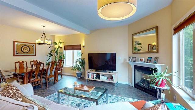 2 Riverstone Ct, Highland Mills, NY 10930 - living area with healthy amount of natural light, a chandelier, and a glass covered fireplace
