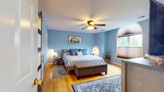 2 Riverstone Ct, Highland Mills, NY 10930 - bedroom with light wood finished floors, a ceiling fan, and a barn door