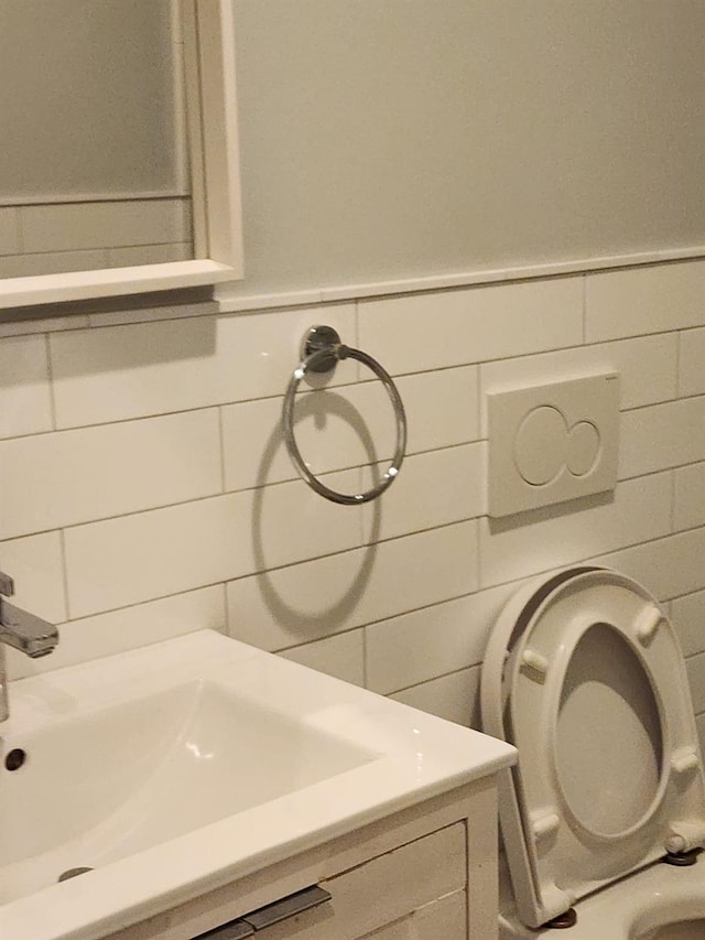 7 E Blvd, East Rockaway, NY 11518 - bathroom featuring tile walls, vanity, and wainscoting