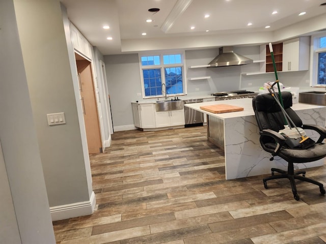 7 E Blvd, East Rockaway, NY 11518 - kitchen with open shelves, a raised ceiling, light wood-type flooring, wall chimney exhaust hood, and recessed lighting