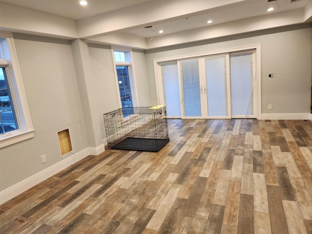 7 E Blvd, East Rockaway, NY 11518 - unfurnished living room featuring wood finished floors, a raised ceiling, french doors, and recessed lighting