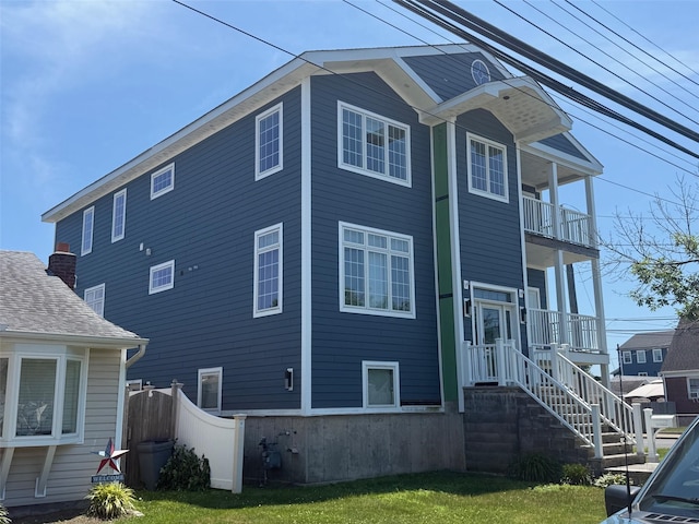7 E Blvd, East Rockaway, NY 11518 - view of property exterior featuring a balcony and a shingled roof
