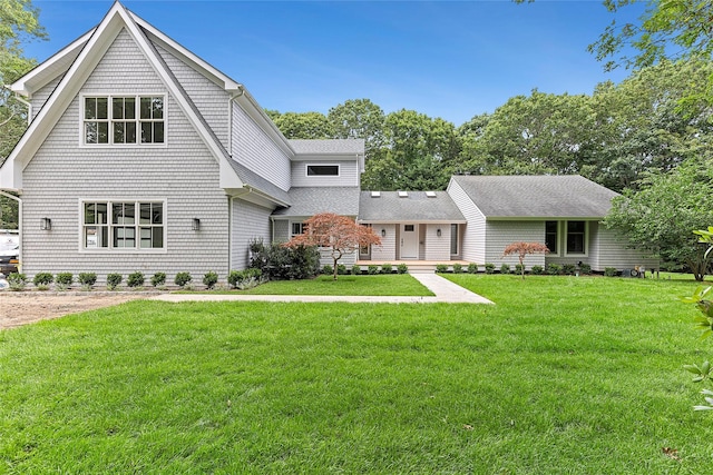 2 Herrick Ln, Southampton, NY 11968 - view of front of house featuring a shingled roof and a front yard