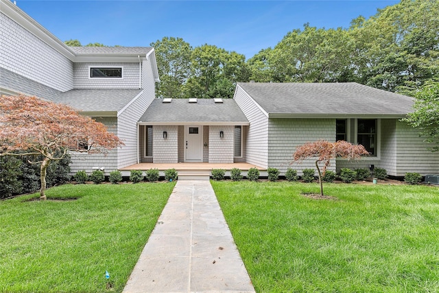 2 Herrick Ln, Southampton, NY 11968 - view of front of house featuring roof with shingles and a front lawn