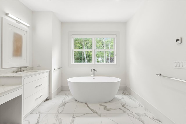 2 Herrick Ln, Southampton, NY 11968 - full bath with vanity, a freestanding tub, and marble look tile flooring