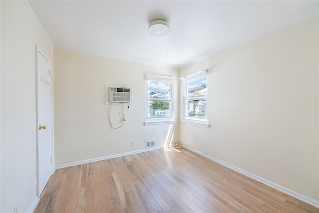 16346 21st Rd, Whitestone, NY 11357 - spare room with light wood-style flooring and a wall unit AC