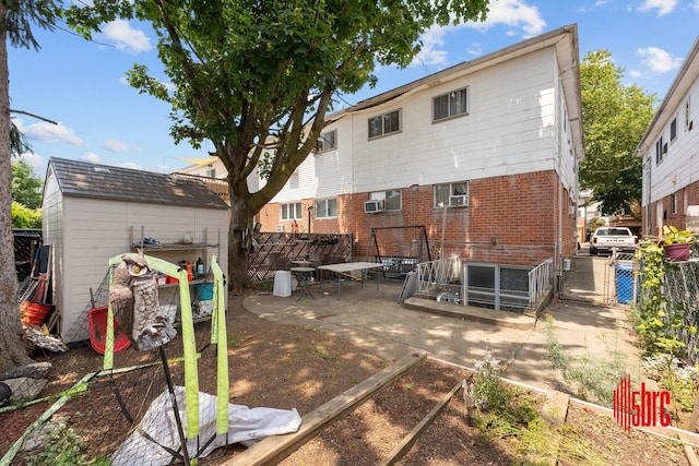 2725 E 65th St, Brooklyn, NY 11234 - back of property with a gate, brick siding, and a patio