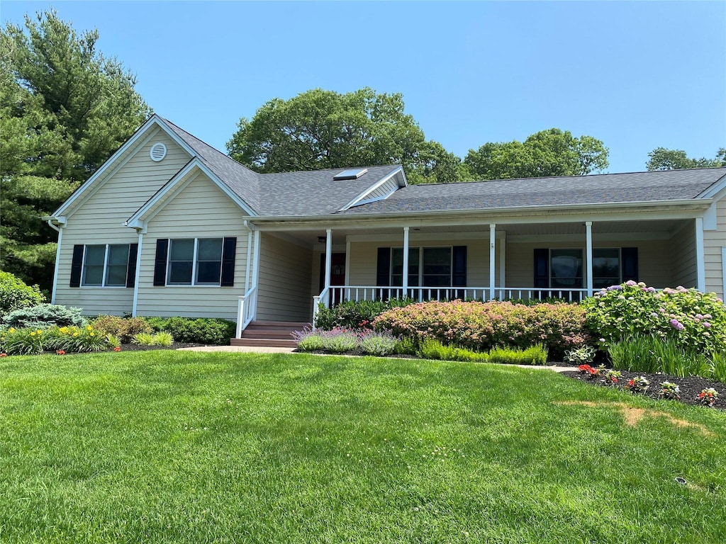 17 Wood Hollow Ln, Northport, NY 11768 - ranch-style house featuring a shingled roof, covered porch, and a front lawn
