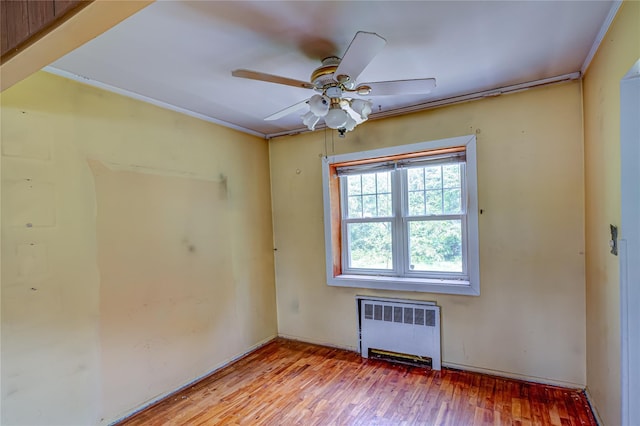 1435 Peters Blvd, Bay Shore, NY 11706 - spare room with radiator, wood finished floors, and ceiling fan