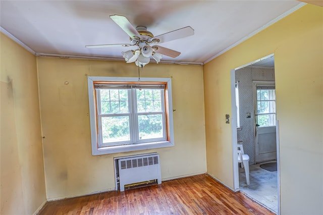 1435 Peters Blvd, Bay Shore, NY 11706 - unfurnished room with radiator heating unit, ceiling fan, crown molding, and wood finished floors