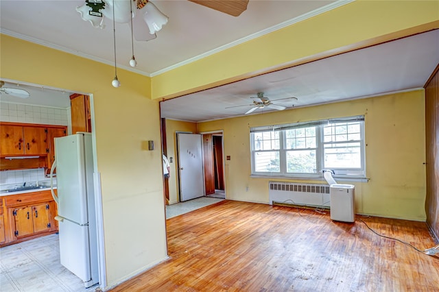1435 Peters Blvd, Bay Shore, NY 11706 - kitchen featuring ceiling fan, freestanding refrigerator, light wood-type flooring, radiator, and crown molding
