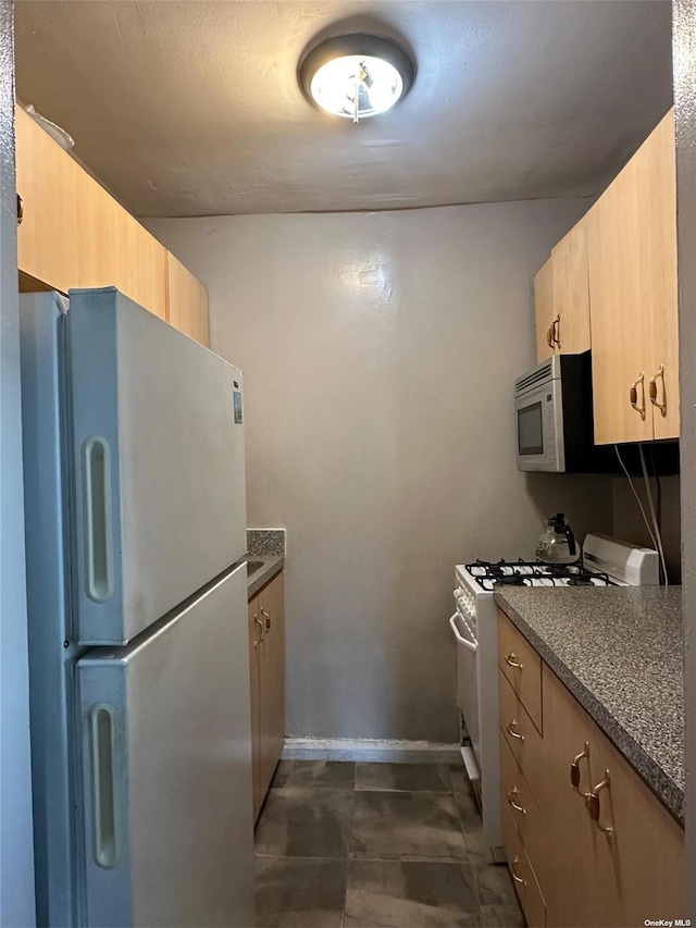 78-06 46th Ave Unit 6F, Elmhurst, NY 11373 - kitchen featuring white appliances and dark countertops
