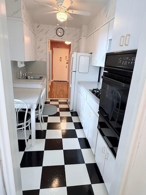 210-15 23rd Ave Unit 4E, Bayside, NY 11360 - kitchen featuring tile patterned floors, white cabinets, ceiling fan, black appliances, and light countertops