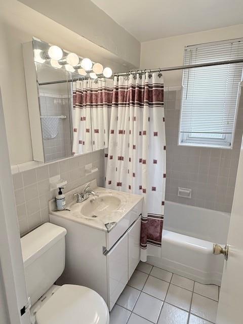 210-15 23rd Ave Unit 4E, Bayside, NY 11360 - full bath featuring tile patterned flooring, vanity, shower / tub combo, and tile walls