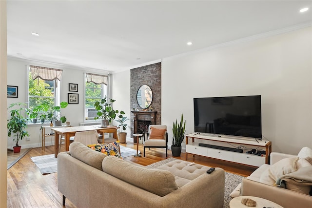 228 Pacific St, Brooklyn, NY 11201 - living room with ornamental molding, light wood-type flooring, a large fireplace, and recessed lighting