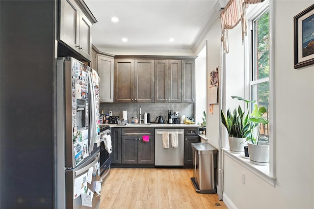 228 Pacific St, Brooklyn, NY 11201 - kitchen featuring light countertops, light wood finished floors, appliances with stainless steel finishes, tasteful backsplash, and crown molding