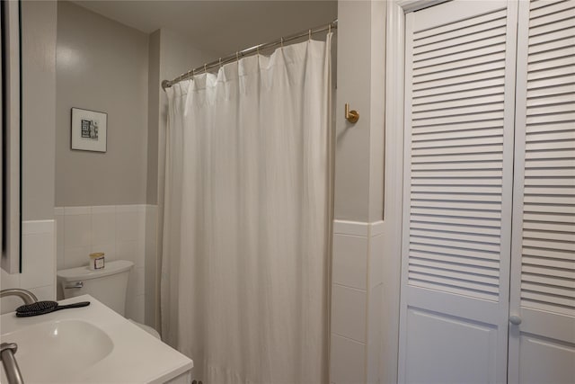 228 Pacific St, Brooklyn, NY 11201 - full bathroom featuring tile walls, wainscoting, vanity, and curtained shower