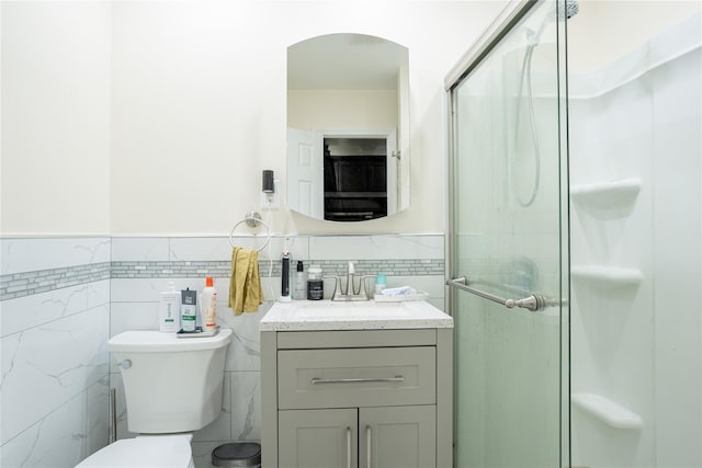 228 Pacific St, Brooklyn, NY 11201 - bathroom featuring tile walls, vanity, a stall shower, and a wainscoted wall
