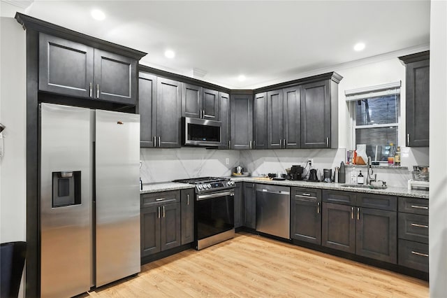 228 Pacific St, Brooklyn, NY 11201 - kitchen with appliances with stainless steel finishes, light wood-style flooring, backsplash, light stone counters, and recessed lighting