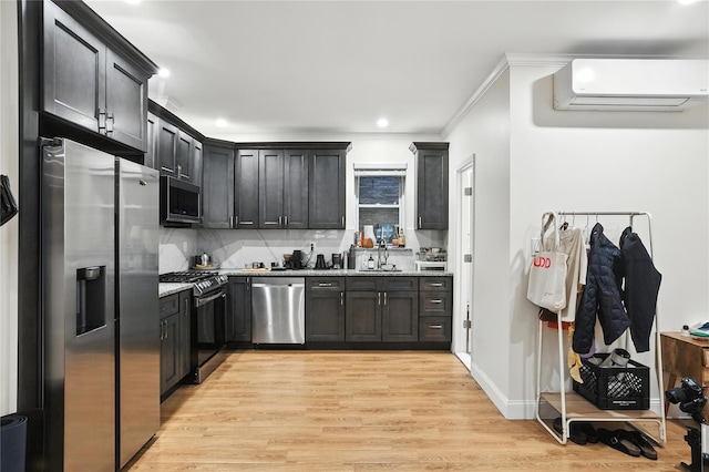 228 Pacific St, Brooklyn, NY 11201 - kitchen featuring stainless steel appliances, light wood-style flooring, crown molding, a wall mounted air conditioner, and recessed lighting