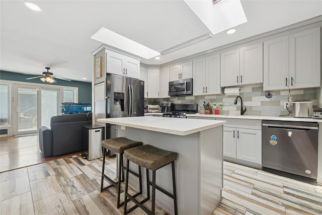 76 Cadman Ave, Babylon, NY 11702 - kitchen with a skylight, stainless steel appliances, recessed lighting, light countertops, and tasteful backsplash