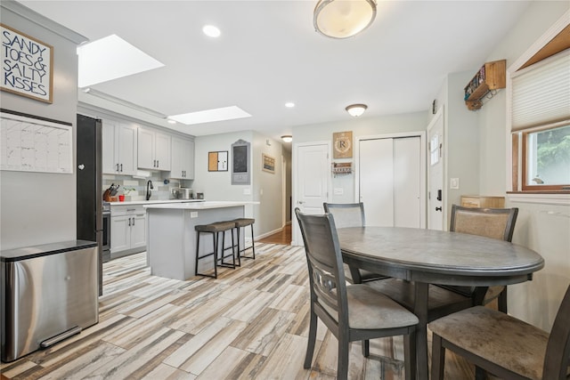 76 Cadman Ave, Babylon, NY 11702 - dining room with a skylight, recessed lighting, and light wood-style flooring