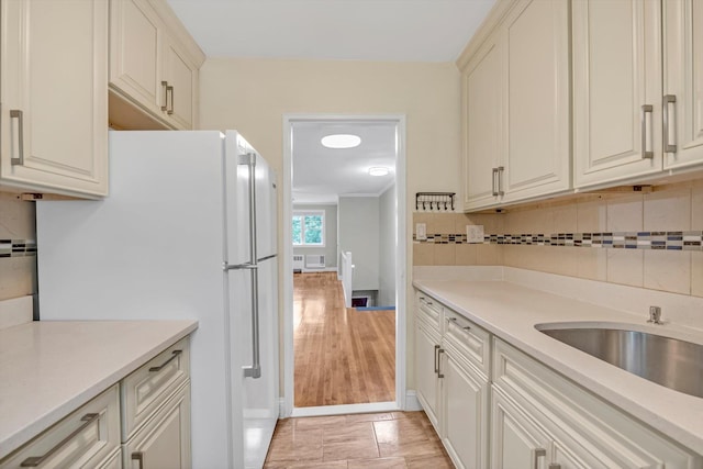 77-17 Springfield Blvd Unit B, Bayside, NY 11364 - kitchen with freestanding refrigerator, decorative backsplash, and light countertops