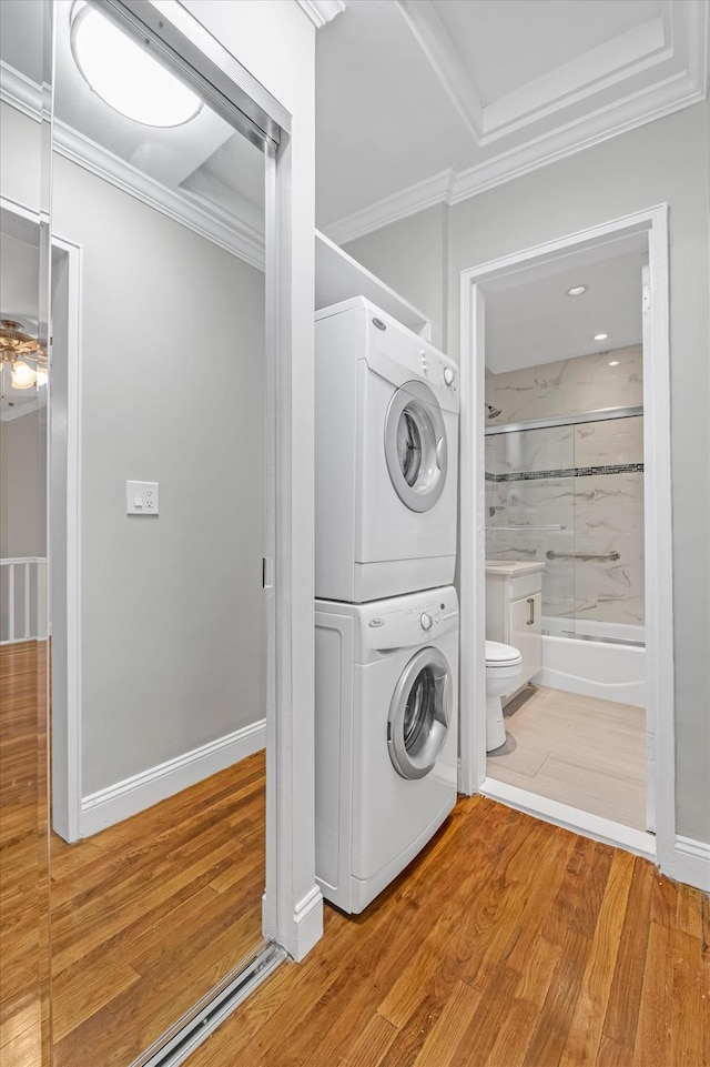 77-17 Springfield Blvd Unit B, Bayside, NY 11364 - washroom featuring estacked washer and dryer, light wood-style flooring, and ornamental molding