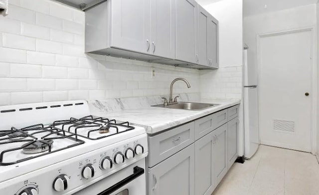 153-25 88th St Unit 1J, Howard Beach, NY 11414 - kitchen featuring white appliances, decorative backsplash, light tile patterned floors, and light stone counters
