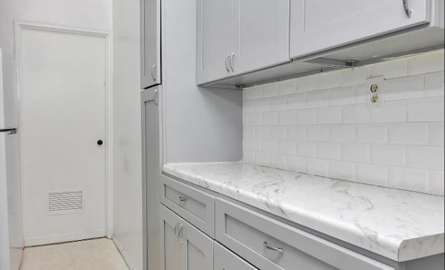 153-25 88th St Unit 1J, Howard Beach, NY 11414 - kitchen featuring tasteful backsplash, freestanding refrigerator, and light stone countertops