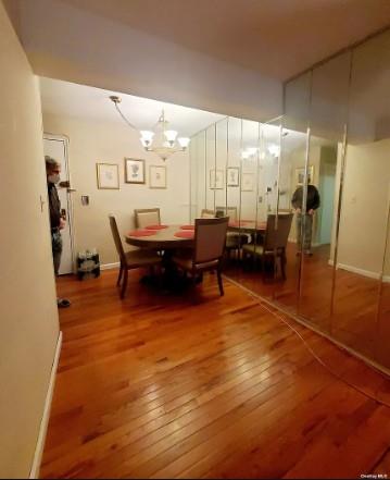 153-25 88th St Unit 1J, Howard Beach, NY 11414 - dining space with wood-type flooring and a chandelier