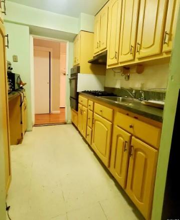 153-25 88th St Unit 1J, Howard Beach, NY 11414 - kitchen featuring dark countertops, a warming drawer, under cabinet range hood, and stainless steel oven