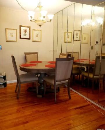 153-25 88th St Unit 1J, Howard Beach, NY 11414 - dining area featuring a chandelier and wood finished floors