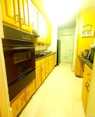 153-25 88th St Unit 1J, Howard Beach, NY 11414 - kitchen with black oven, a warming drawer, and freestanding refrigerator