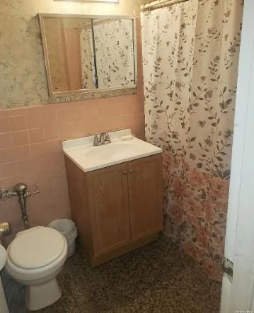 153-25 88th St Unit 1J, Howard Beach, NY 11414 - bathroom with vanity, a wainscoted wall, a shower with curtain, and tile walls