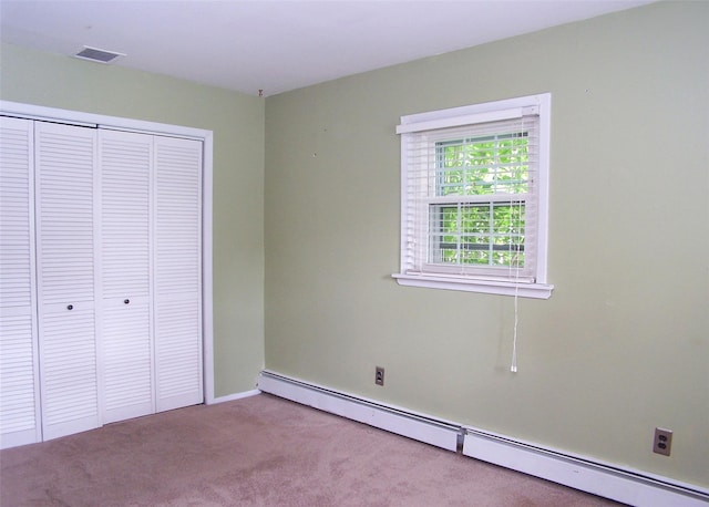 1439 Ocean Ave, Bohemia, NY 11716 - unfurnished bedroom featuring a baseboard heating unit, carpet floors, and a closet