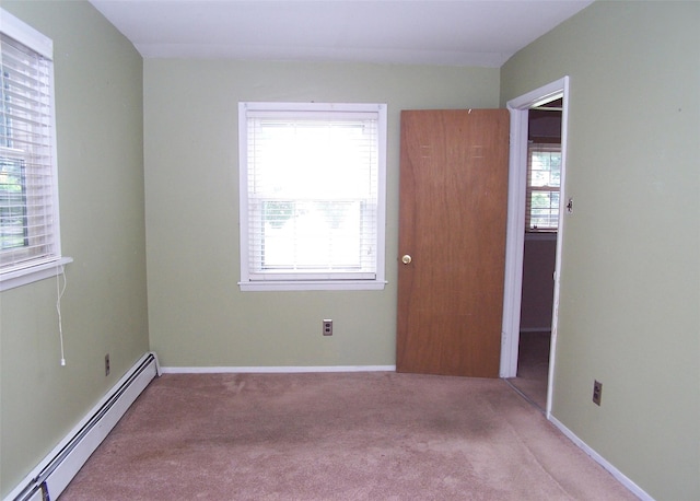 1439 Ocean Ave, Bohemia, NY 11716 - spare room with a baseboard radiator and carpet floors