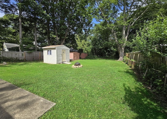 1439 Ocean Ave, Bohemia, NY 11716 - fenced backyard featuring a storage unit and an outdoor fire pit