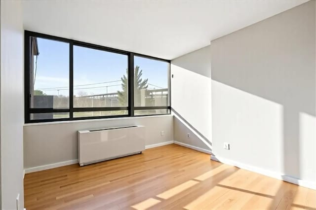 2287 Johnson Ave Unit 3A, Bronx, NY 10463 - unfurnished room featuring plenty of natural light, wood finished floors, and radiator heating unit
