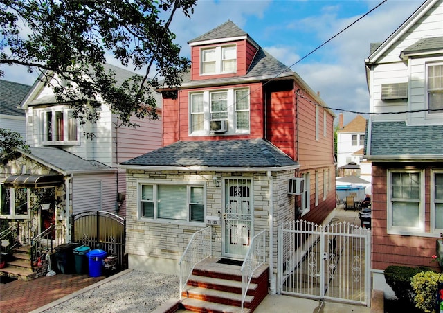 78-33 64th St, Glendale, NY 11385 - view of front facade featuring a gate, roof with shingles, and stone siding