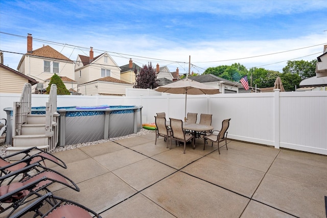 78-33 64th St, Glendale, NY 11385 - fenced backyard featuring outdoor dining area, a patio area, and a residential view