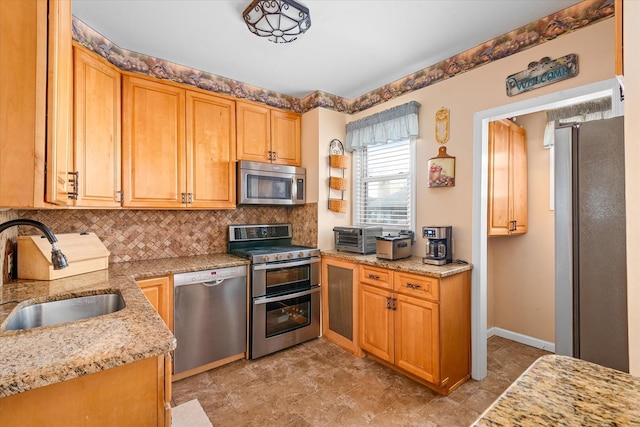 78-33 64th St, Glendale, NY 11385 - kitchen featuring stainless steel appliances, tasteful backsplash, light stone countertops, and stone finish flooring