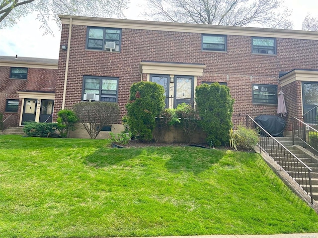 219-36 74th Ave Unit 323A1, Bayside, NY 11364 - view of front facade with brick siding and a front lawn