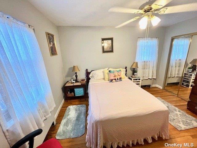 219-36 74th Ave Unit 323A1, Bayside, NY 11364 - bedroom with wood finished floors and ceiling fan